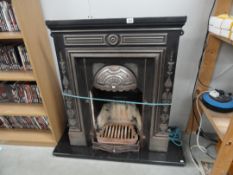 A cast iron metal fire surround and fire place
