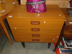 A 4 drawer chest of drawers on legs