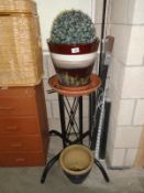 A black plant stand and garden pots