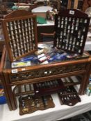 A quantity of collectors tea spoons and thimbles with racks / cabinets