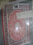 A red patterned rug, 198 x 134 cm. £20.00 - £30.