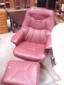 A leather swivel chair with stool (leather on arms faded)