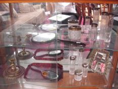 A collection of dressing table items including mirror, glass bottles,