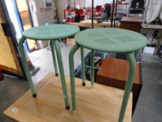 A pair of retro green metal stools