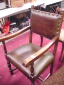 An early 20th C oak carver chair with leather seat and back