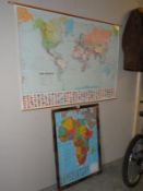 A large hanging world map and framed glazed map of Africa