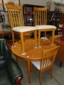 A round extending dining table and 4 chairs