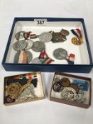 A collection of Royal Commemorative medals and military badges