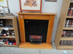 A wooden fire surround and electric fire