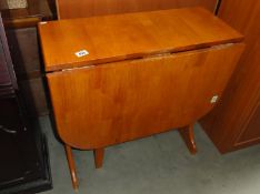 A teak gate leg table