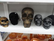 A large skull figure and fiver others