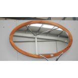 An oval wall mirror