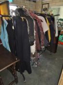 A rack of clothes including faux fur jackets etc.