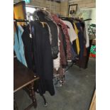 A rack of clothes including faux fur jackets etc.