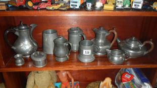 A box of pewter items including tankards & teapots etc.