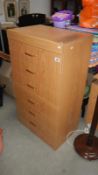 A 6 drawer teak effect chest of drawers