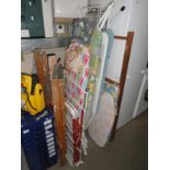 A quantity of ironing boards & clothes airers etc.