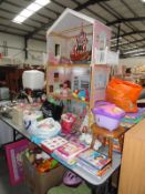 A large dolls house with a large quantity of children's toys, shoes, books & Dvd's etc.