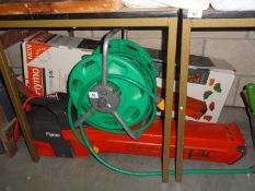 A Flymo electric garden vacuum & a hose pipe