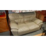 A cream 2 seater leather sofa