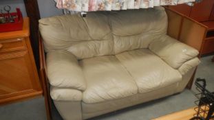 A cream 2 seater leather sofa
