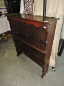 A dark wood stained bookshelf with 2 shelves