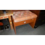 A deep buttoned upholstered teak effect stool