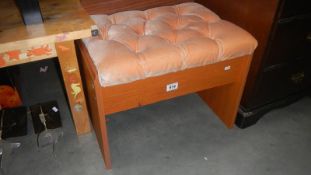 A deep buttoned upholstered teak effect stool