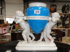 A Minton style figure of 2 cherubs carrying water carier marked A/F (arm and part of pole missing