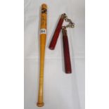 A nunchuck and a replica New York Yankees bat.