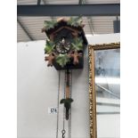 A cuckoo clock with 3 assorted weights