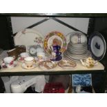 A shelf of assorted tea & dinnerware