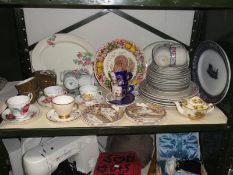 A shelf of assorted tea & dinnerware