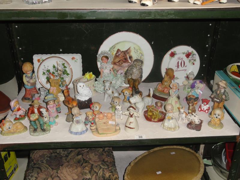 A shelf of assorted figures including animals