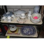 2 shelves of tea & dinnerware including tureen & meat platters etc.
