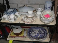 2 shelves of tea & dinnerware including tureen & meat platters etc.