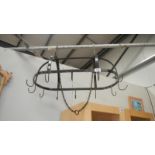 A suspended metal meat hook cradle