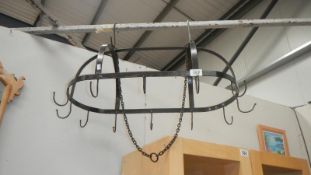 A suspended metal meat hook cradle