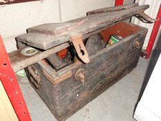 An old wooden chest with hand tools etc (approximately 4ft long)