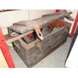 An old wooden chest with hand tools etc (approximately 4ft long)