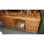 A pine effect double pedestal desk/dressing table