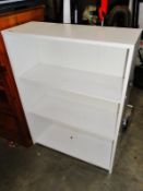 A white bookshelf with 3 shelves