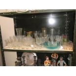 A shelf of glassware including vases & drinking glasses etc.