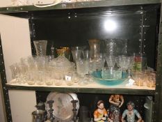 A shelf of glassware including vases & drinking glasses etc.