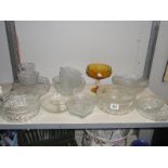 A shelf of assorted glassware