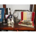 A shelf of silver plate items