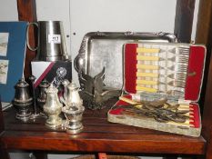 A shelf of silver plate items