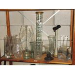 A shelf of glassware including vases