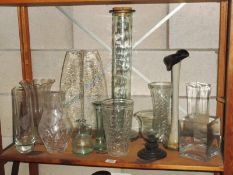 A shelf of glassware including vases