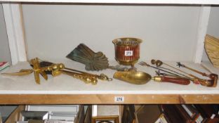 A shelf of brass & copperware